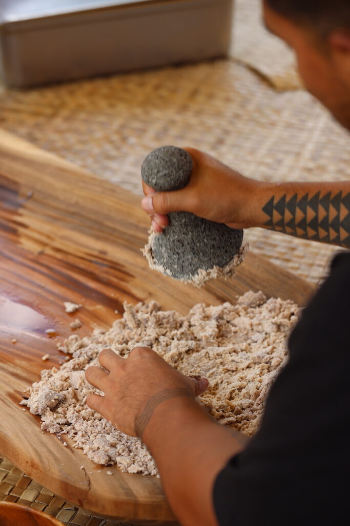 Kāwika Aspili prepares poi, derived from kalo or taro plant freshly picked from the school’s garden. Photo by: Richard Castaneda