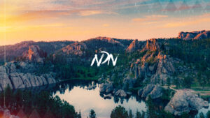 A graphic design of a mountain range landscape image, overlayed with NDN Collective branding.