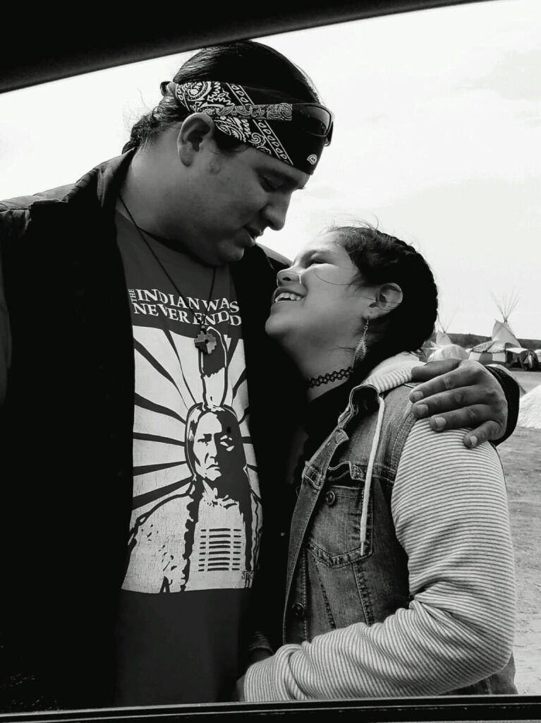 Image of an Oglala Lakota father hugging his daughter in Rapid City, South Dakota.