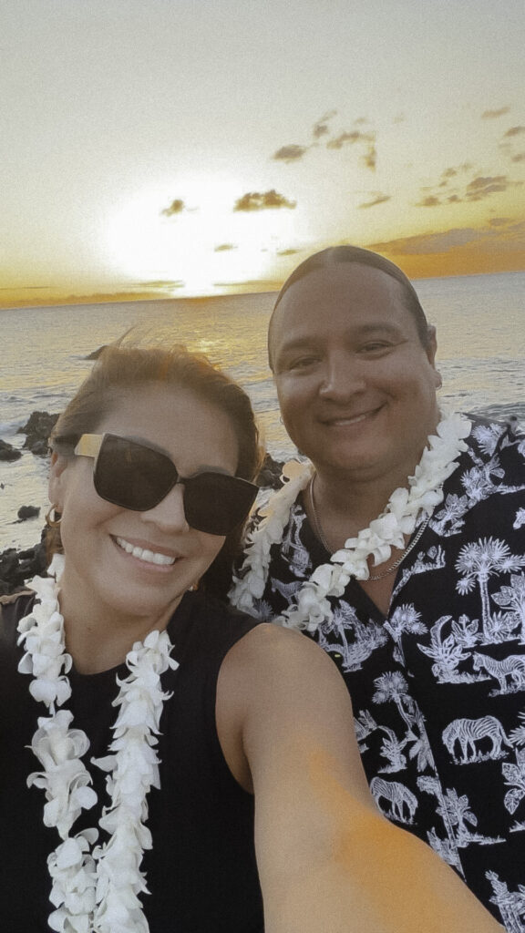An image of a Native American couple enjoying their time together at the beach during sunset in Hawaii.